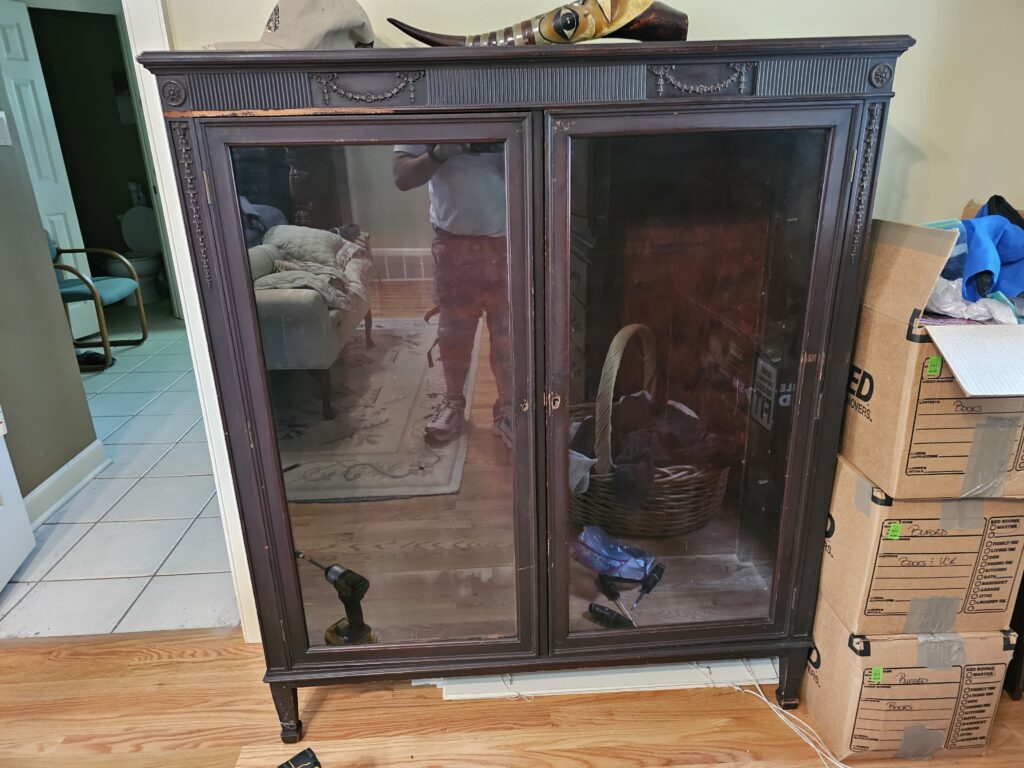Front view of locked antique armoire before unlocking