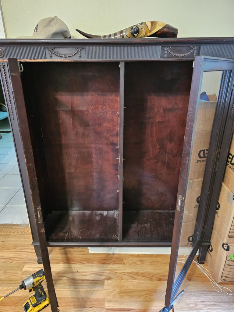 Antique armoire open showing interior after unlocking