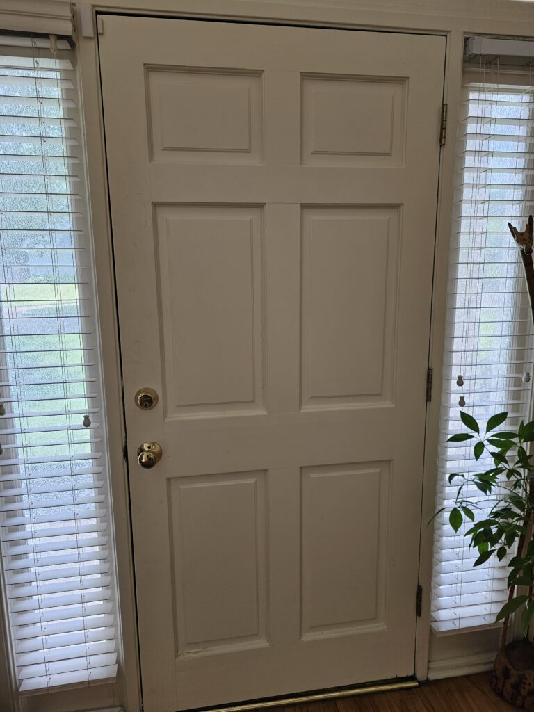 Interior view of white door showing sagging alignment