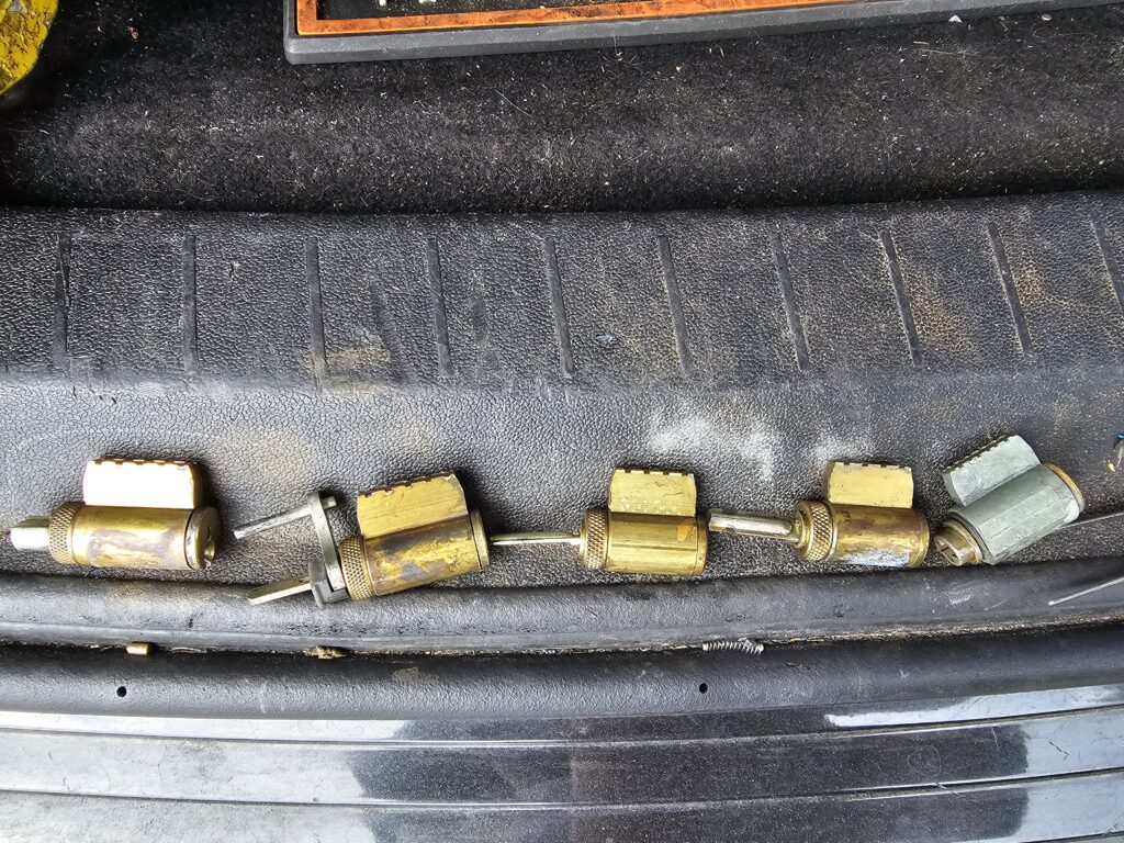 Schlage lock cylinders lined up during rekeying process