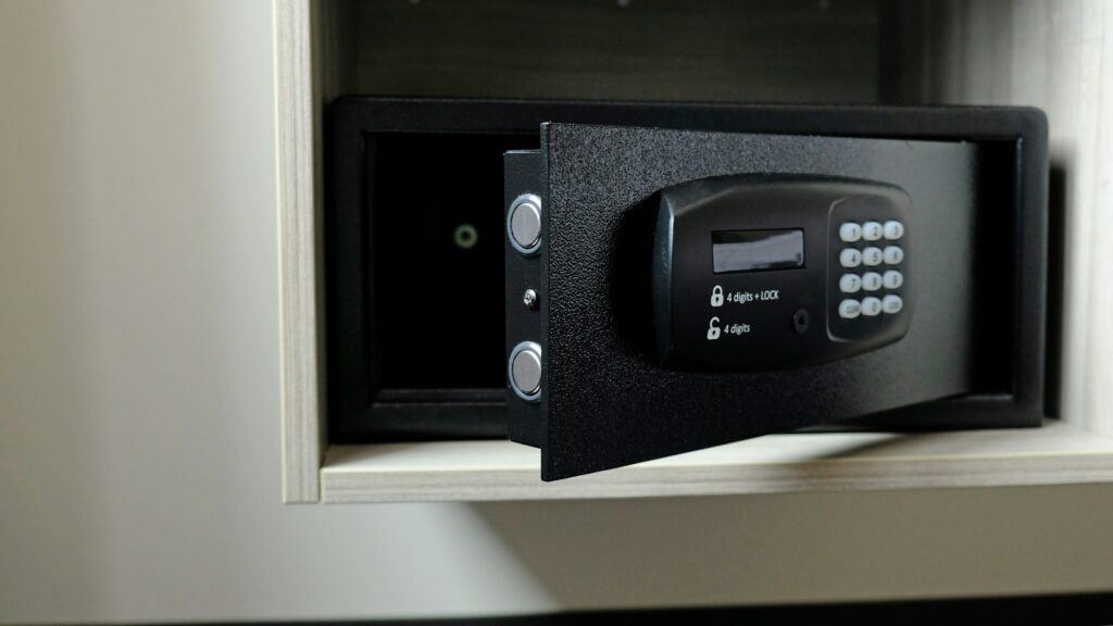 Metal safe box in the closet. Small narrow safe for keeping money or valuables in the hotel.