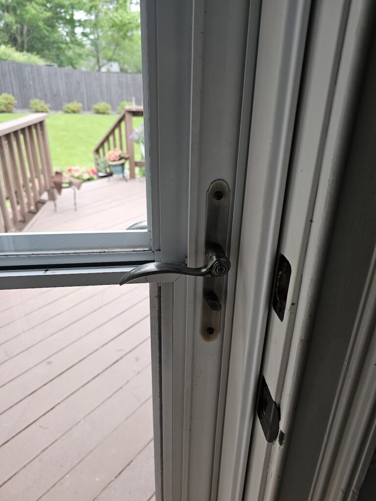 Adjusting storm door handle and latch to fix door alignment in Cordova