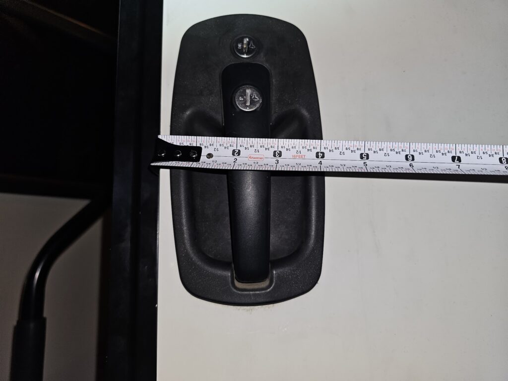 Measuring a vertical RV camper door lock for rekeying and locksmith services.